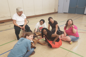 Honey, the therapeutic dog from St. John Ambulance making new friends with some of the participants.