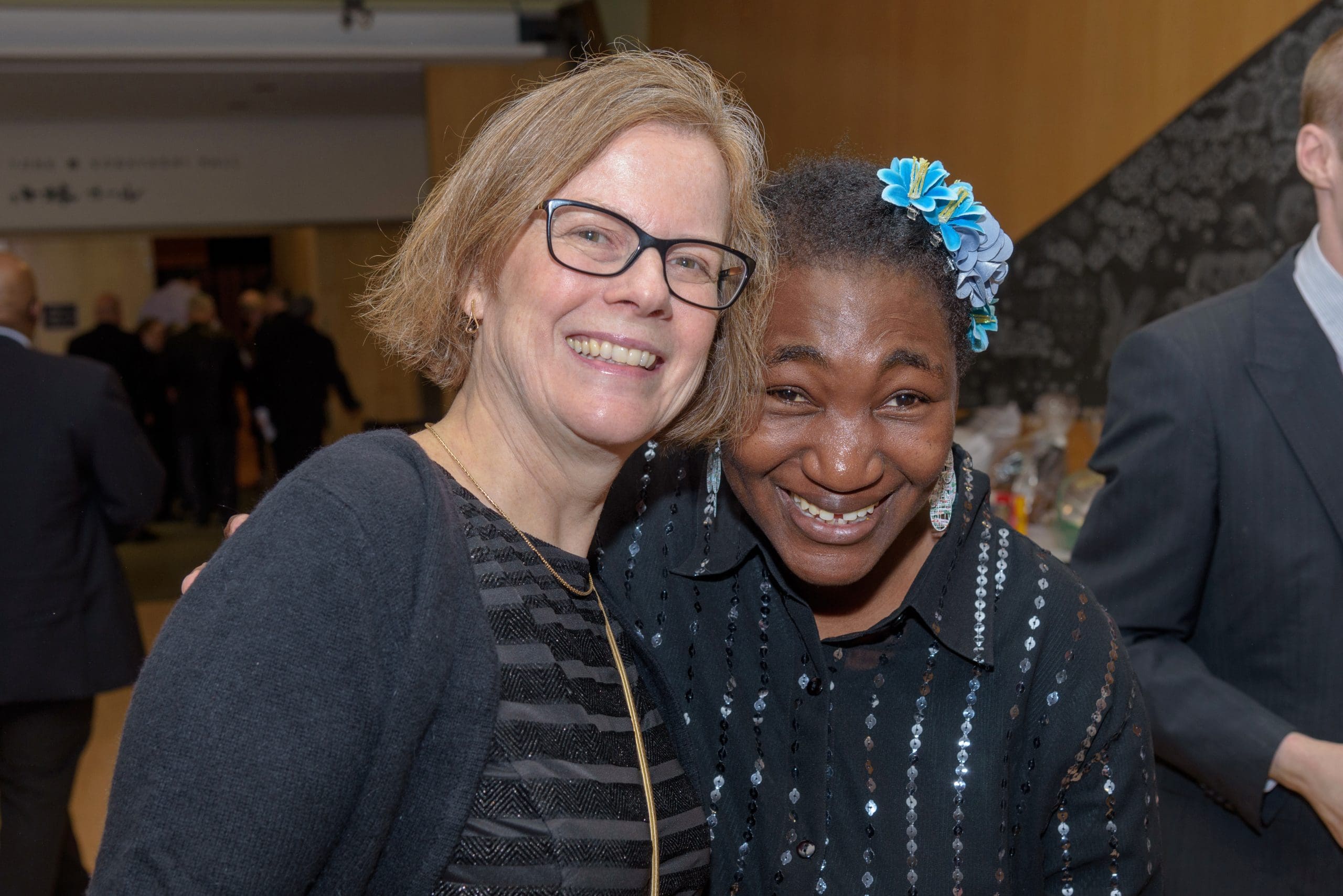 2 women posing together at an event