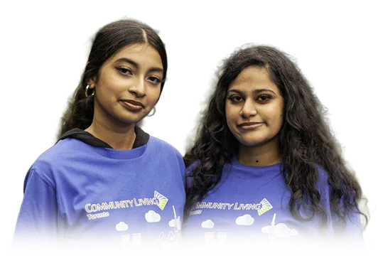 Two smiling young women volunteers wearing Community Living Toronto t-shirts